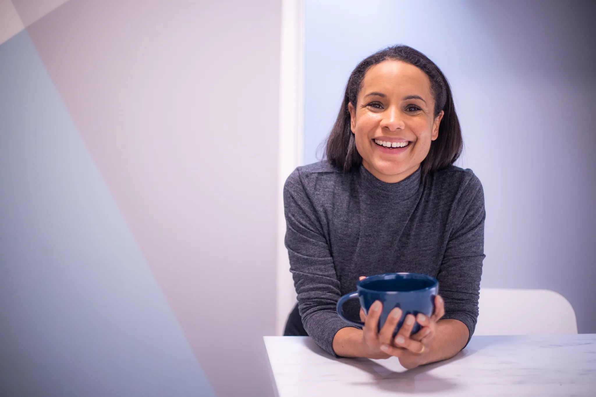 A woman smiling and looking at the camera.